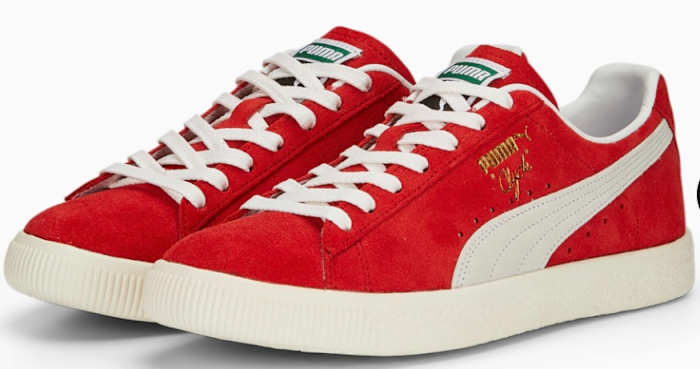 Side view of red and white Puma shoes.